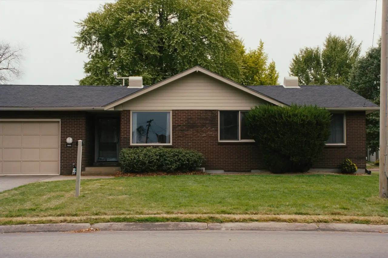 Rendered image of a 1950s brick-front ranch house on a flat lot