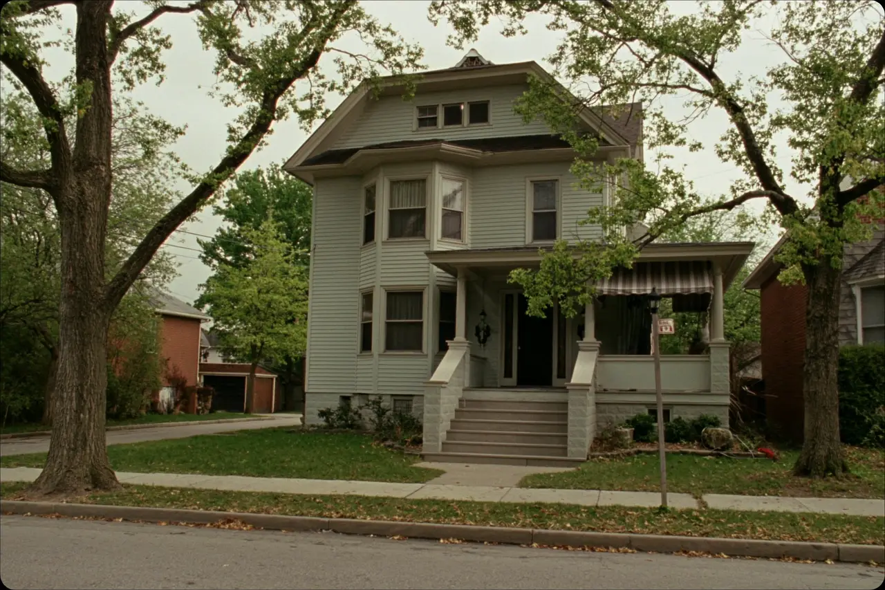 Rendered image of a 1920s colonial with a front porch on a narrow city lot