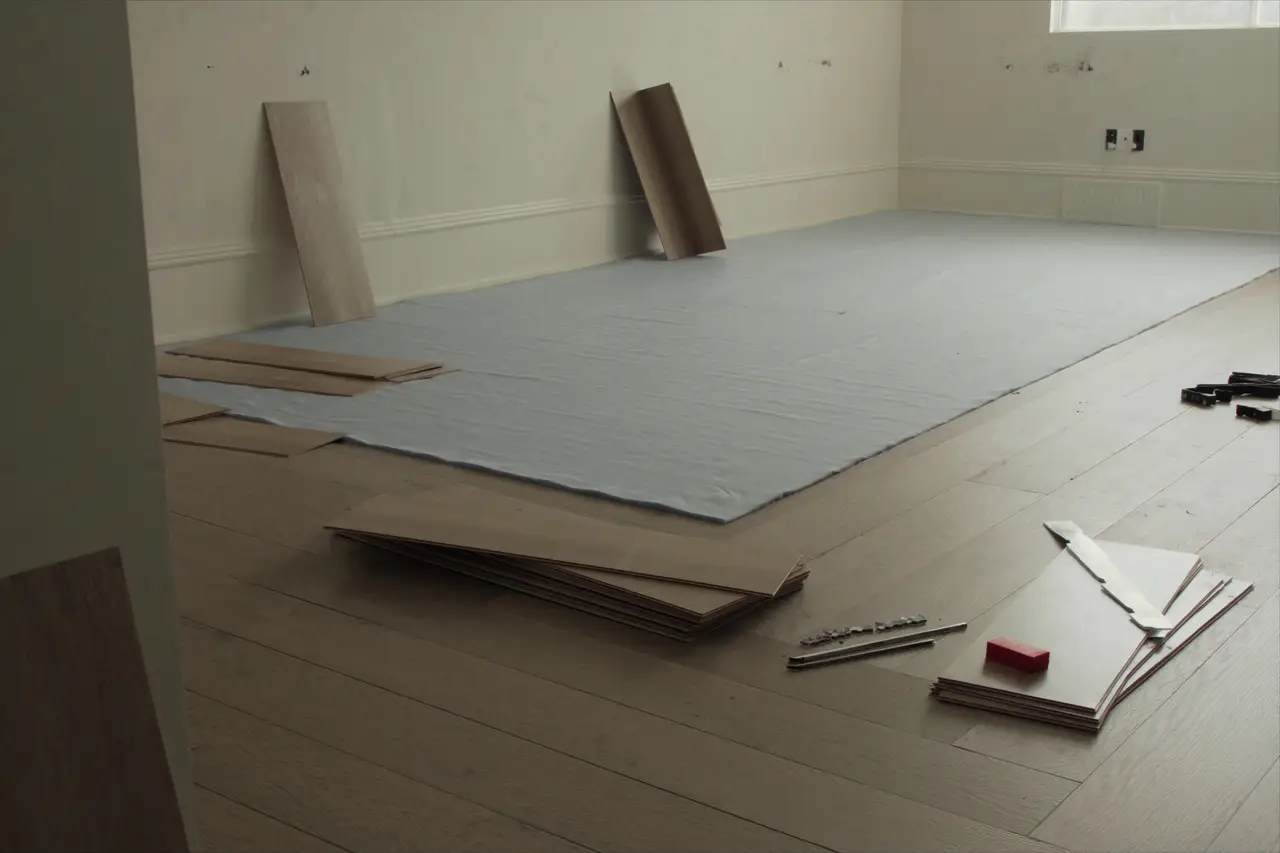 Rendered close-up of vinyl plank flooring being laid over underlayment