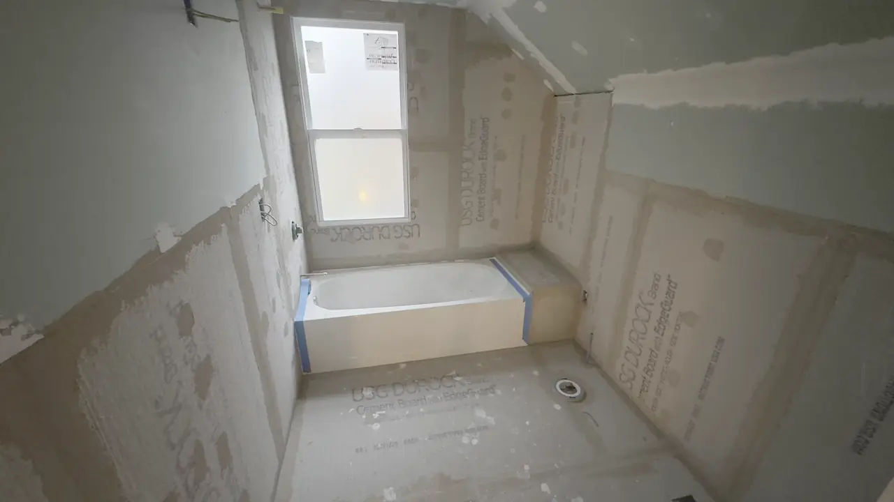 Cement board walls around a tub, before waterproofing.